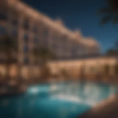 An evening view of a hotel pool illuminated with lights and entertainment